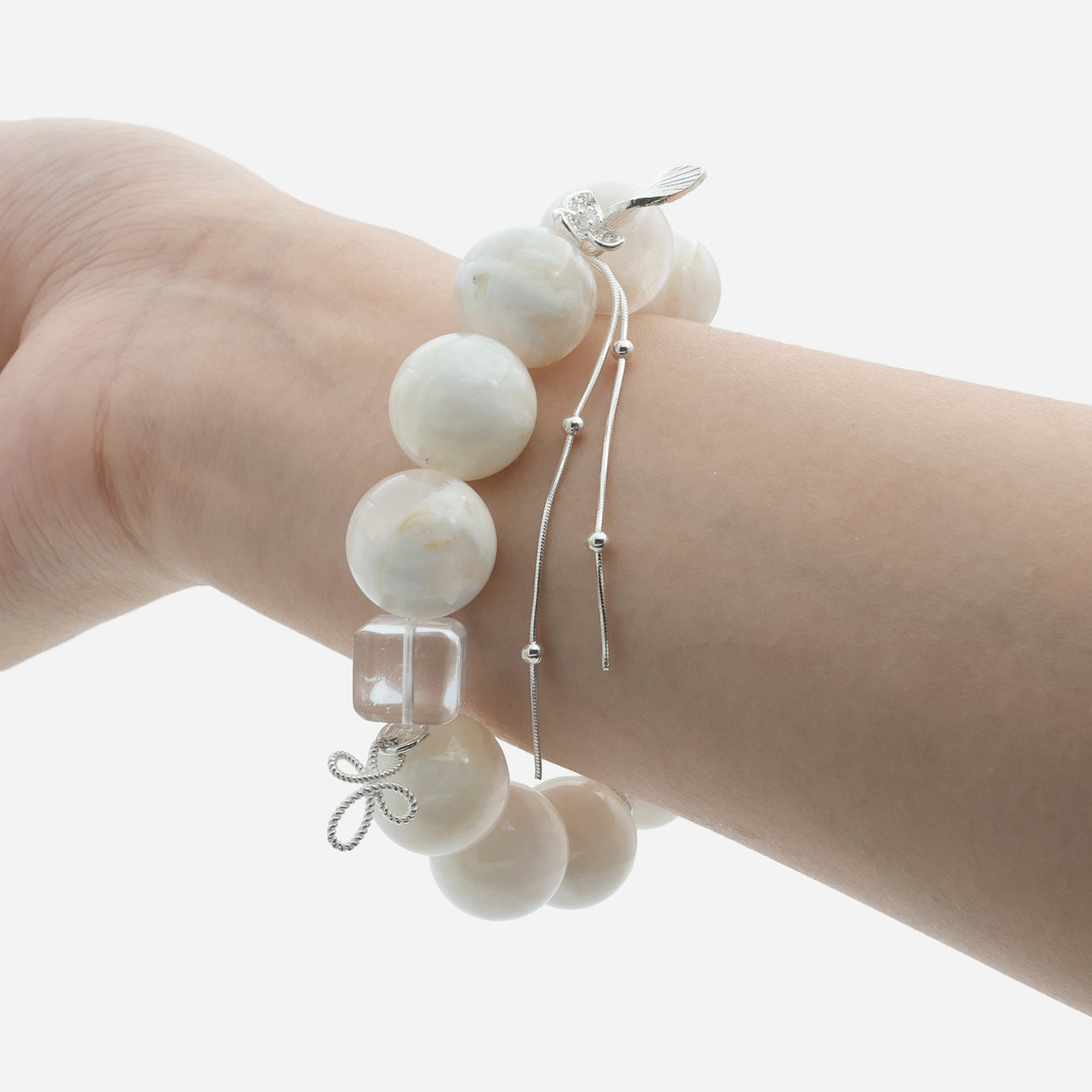Velvet snow ghost quartz bracelet worn on wrist displaying the 15mm creamy white phantom beads and sterling silver