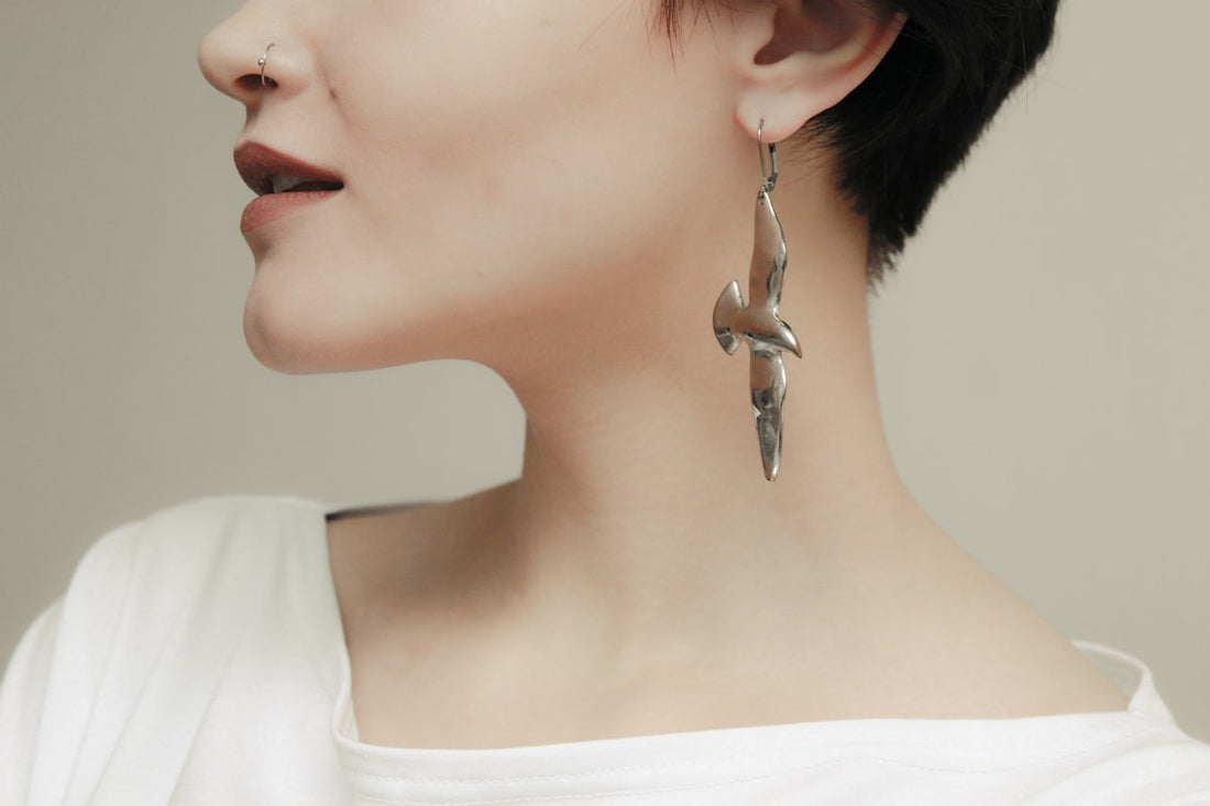 Woman wearing silver earrings demonstrating hypoallergenic jewelry suitable for sensitive skin