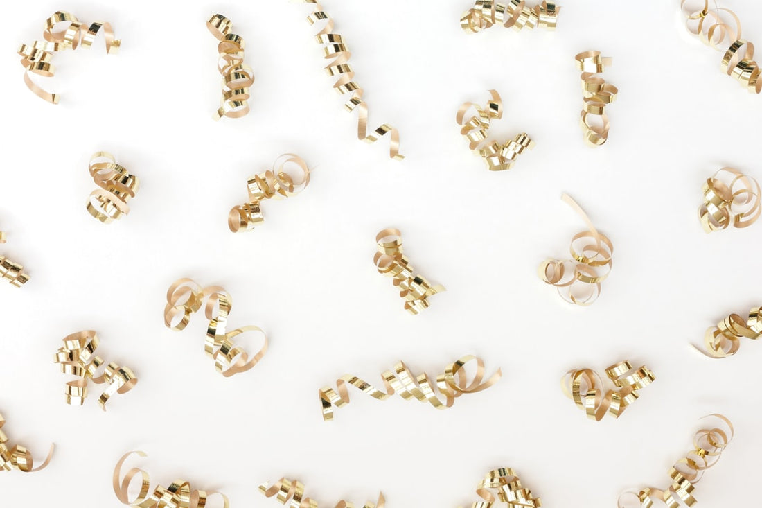 Gold jewelry pieces on white surface representing demi fine jewelry quality