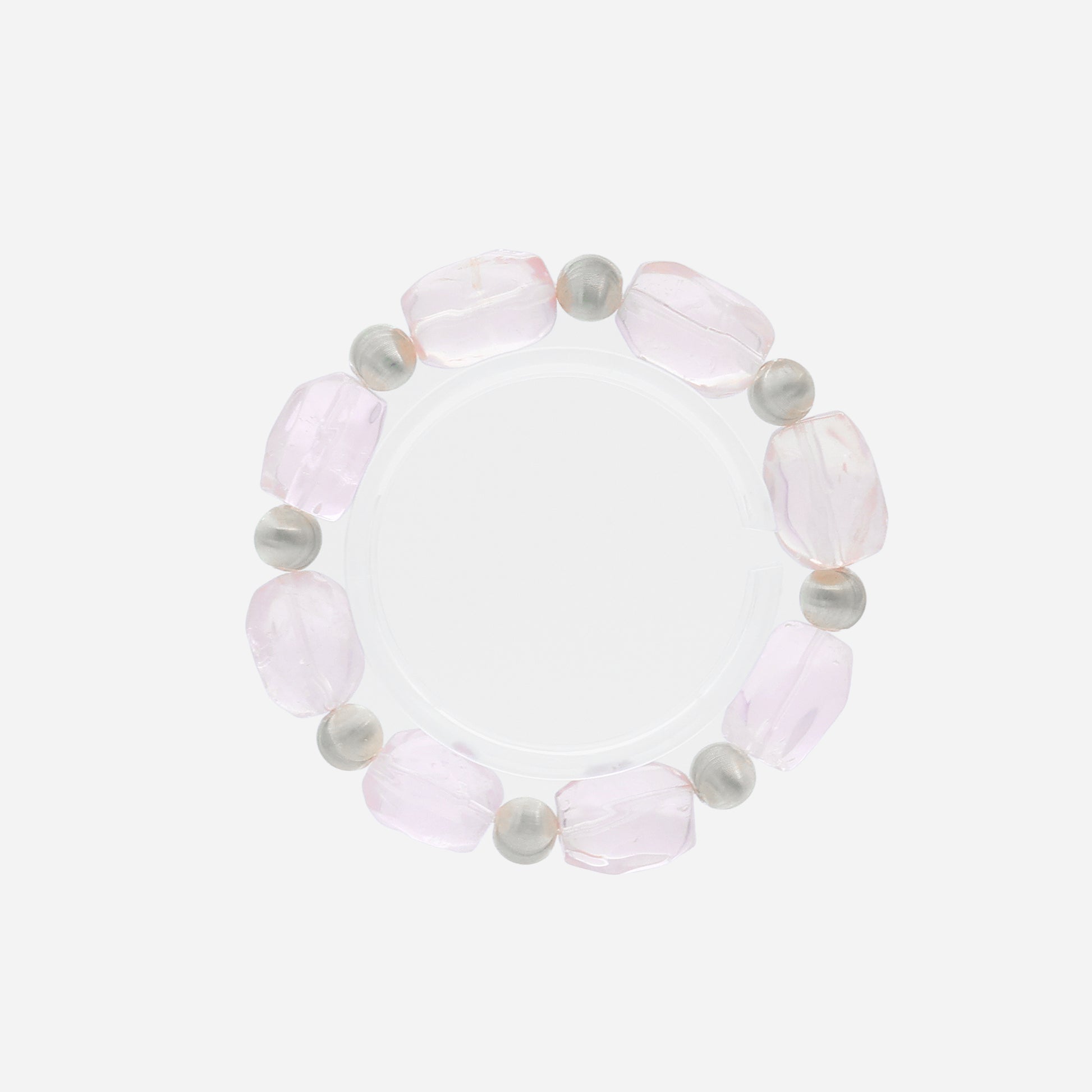 Close-up of handcrafted rose quartz bracelet with organic-shaped beads and matte sterling silver texture