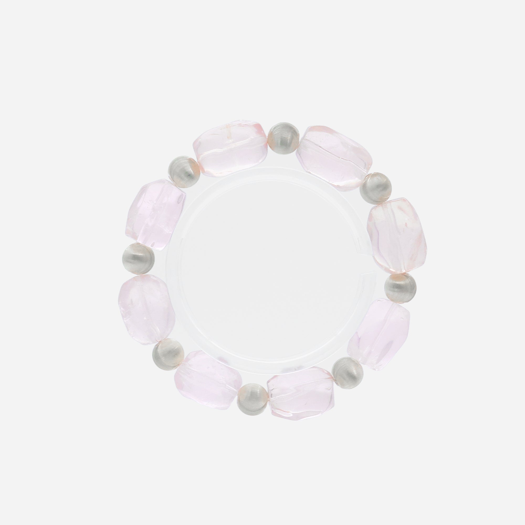 Close-up of handcrafted rose quartz bracelet with organic-shaped beads and matte sterling silver texture