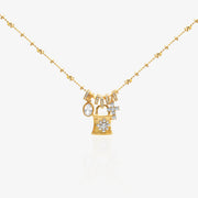 Gold Lock Charm Necklace — vintage padlock pendant with pavé snowflake diamond face, 4 detachable charms including marquise oval, cross star, and graduated baguette tassels, on beaded satellite chain, 18K gold plated sterling silver