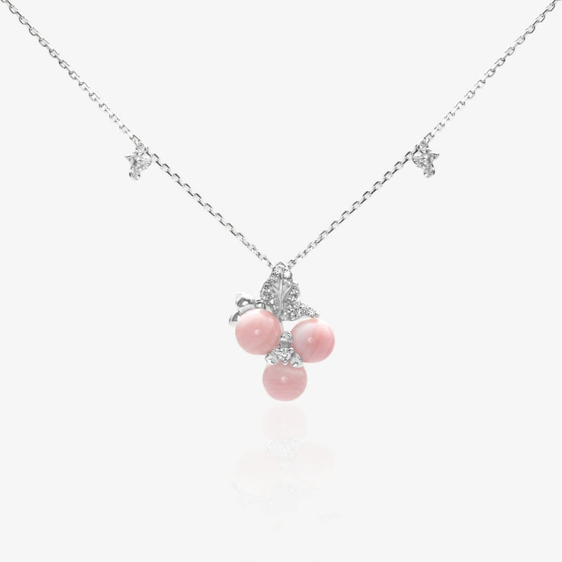 A coquette-style pink queen conch shell necklace featuring three natural shell orbs in a sweet cherry pendant design with rhodium-plated 925 sterling silver leaf accents