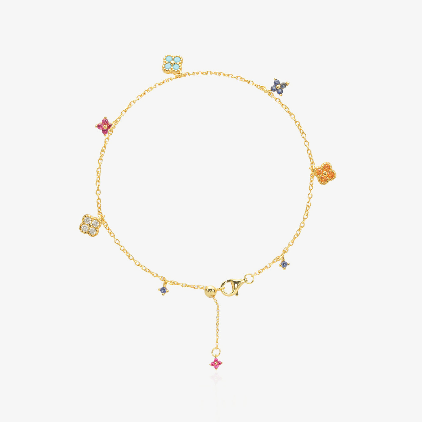Multi-Color Clover Bracelet — six asymmetrical four-leaf clover charms in pastel pink, orange, sky blue, navy, and ice white stones set in 18K gold-plated O-link chain, flat lay