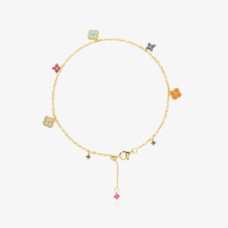 Multi-Color Clover Bracelet — six asymmetrical four-leaf clover charms in pastel pink, orange, sky blue, navy, and ice white stones set in 18K gold-plated O-link chain, flat lay