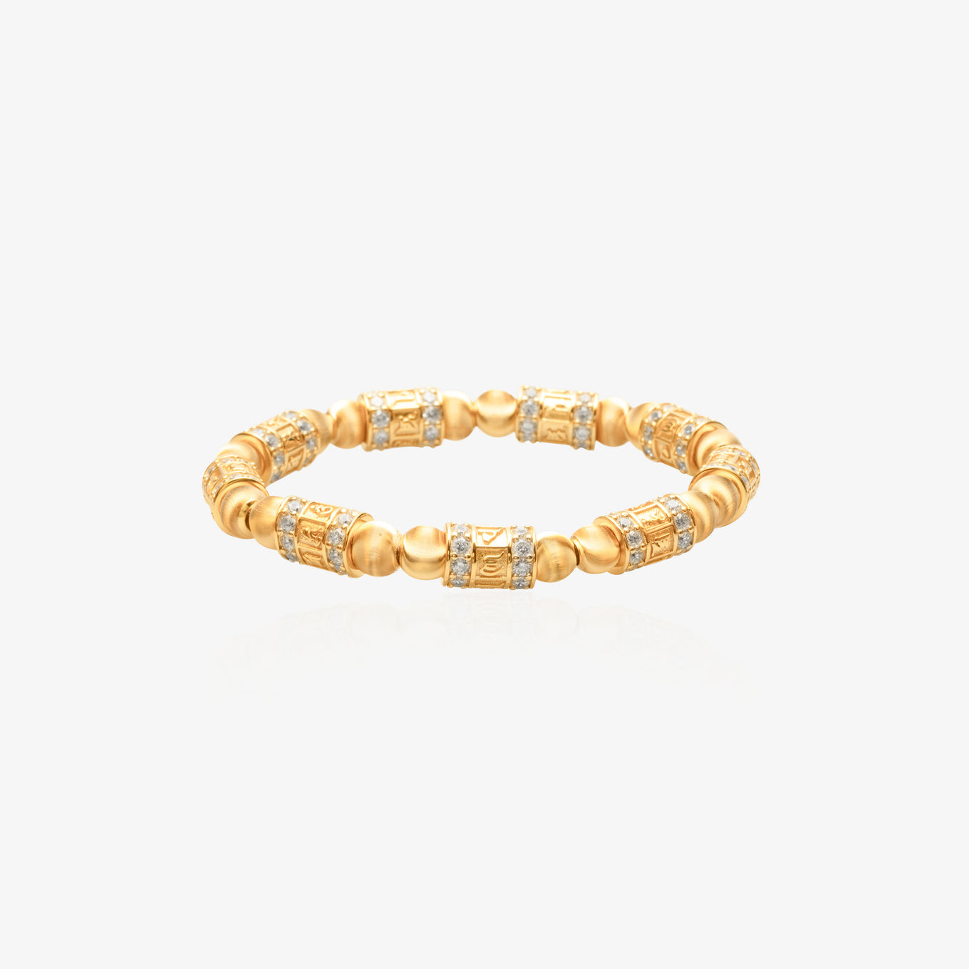 Gold beaded bracelet with alternating carved six-syllable mantra prayer wheel barrel beads and matte gold spacer spheres, diamond pave rings at both ends of each prayer wheel, 18K gold plated, elastic cord, worn on unisex wrist