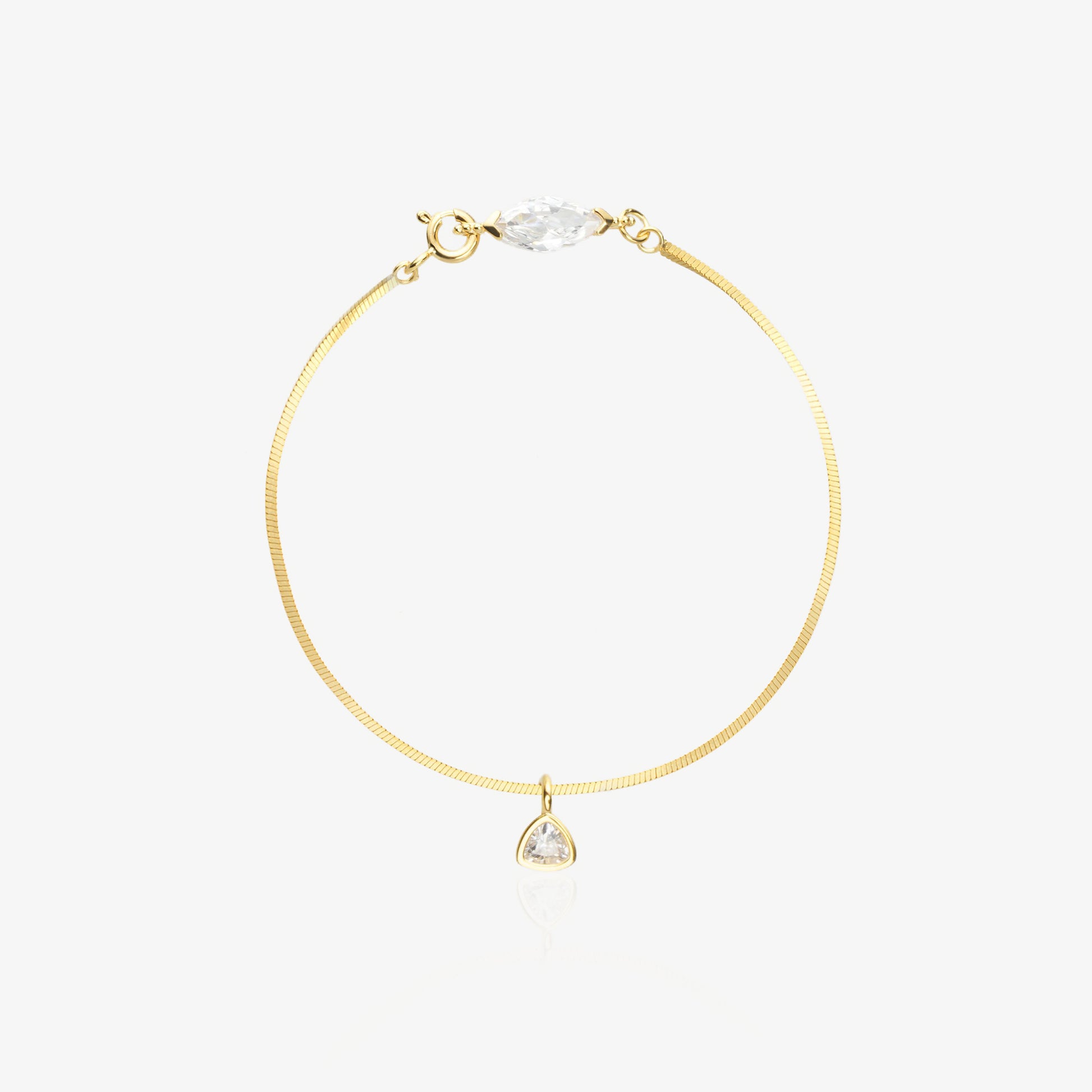 Gold Herringbone Bracelet — flat satin-brushed herringbone chain with horizontal marquise-cut lab diamond near lobster clasp and triangle geometric drop pendant, 18K gold-plated