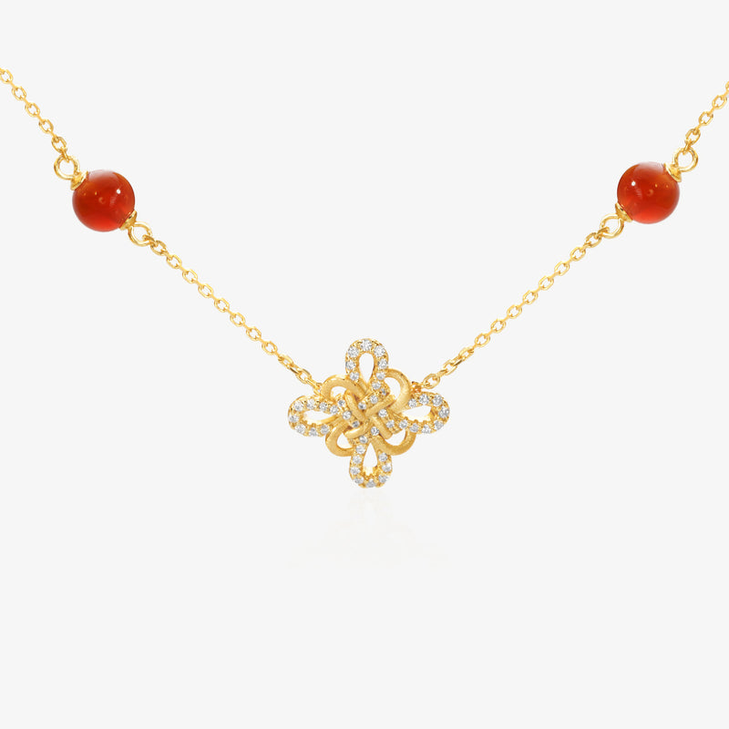 Gold Clover Necklace — Chinese knot pendant shaped as four-leaf clover, natural red agate beads flanking both sides, pavé lab diamond border on outer petals, brushed matte gold finish, O-chain, 18K gold plated sterling silver