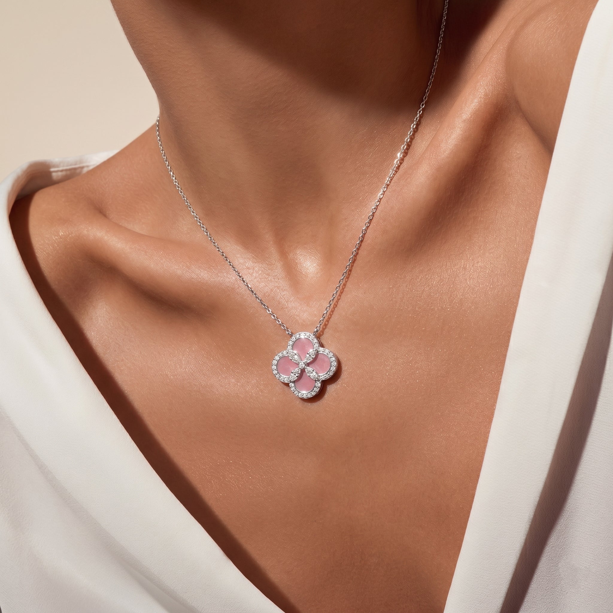 Lifestyle view of the Pink Mother of Pearl clover necklace on a model, showcasing its soft glow and adjustable length.
