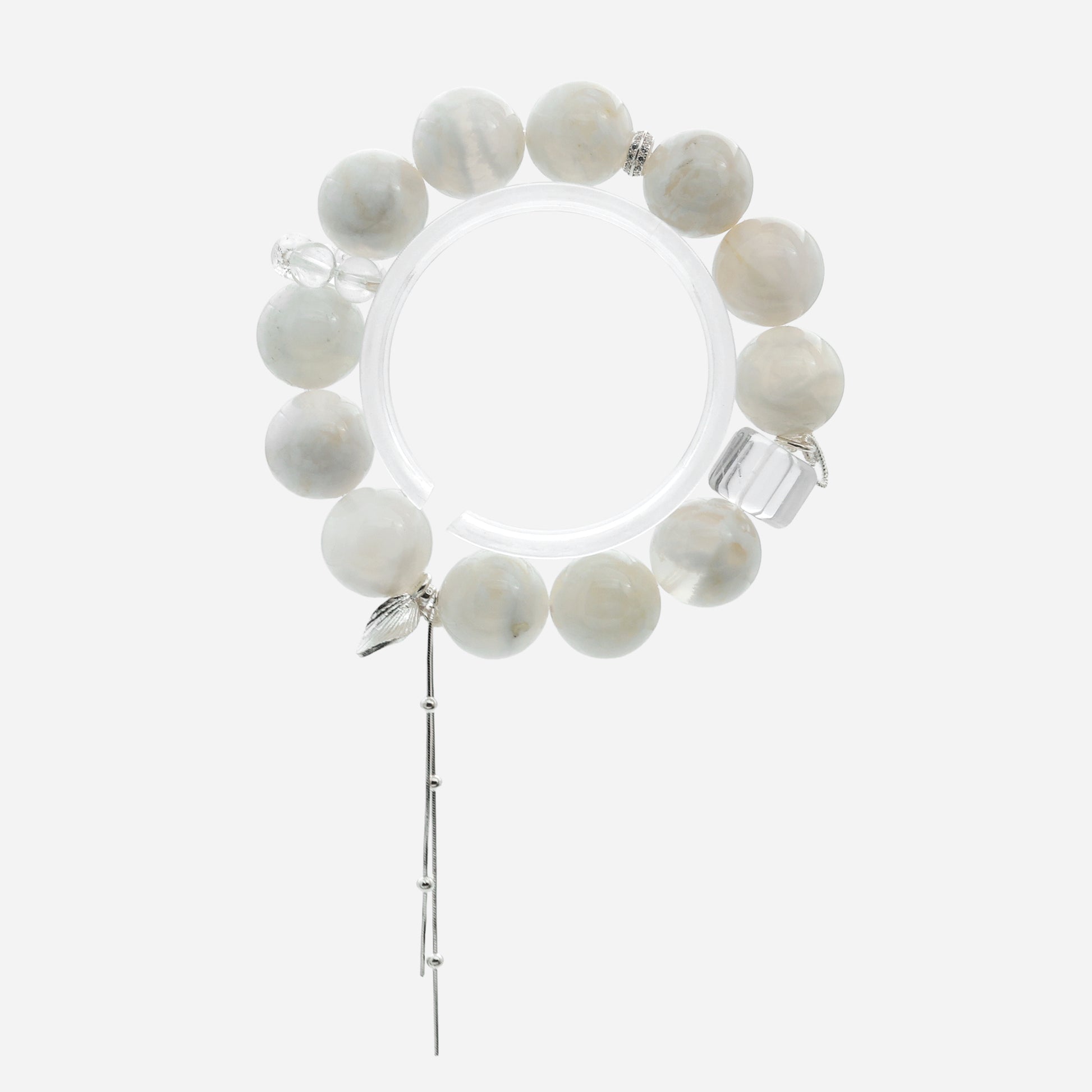 Top-down view of chunky white quartz bracelet showing the 14-15cm petite fit and clear quartz running ring accents