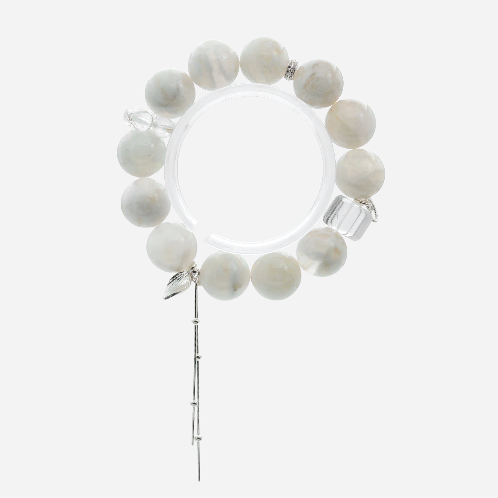 Top-down view of chunky white quartz bracelet showing the 14-15cm petite fit and clear quartz running ring accents