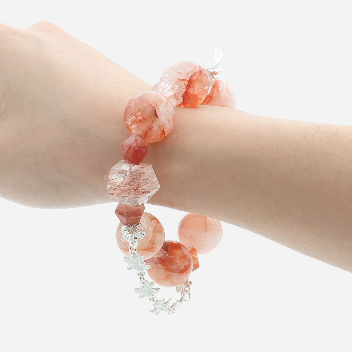 Crimson bloom hematoid fire quartz bracelet worn on wrist displaying the red rutilated quartz pillar beads and