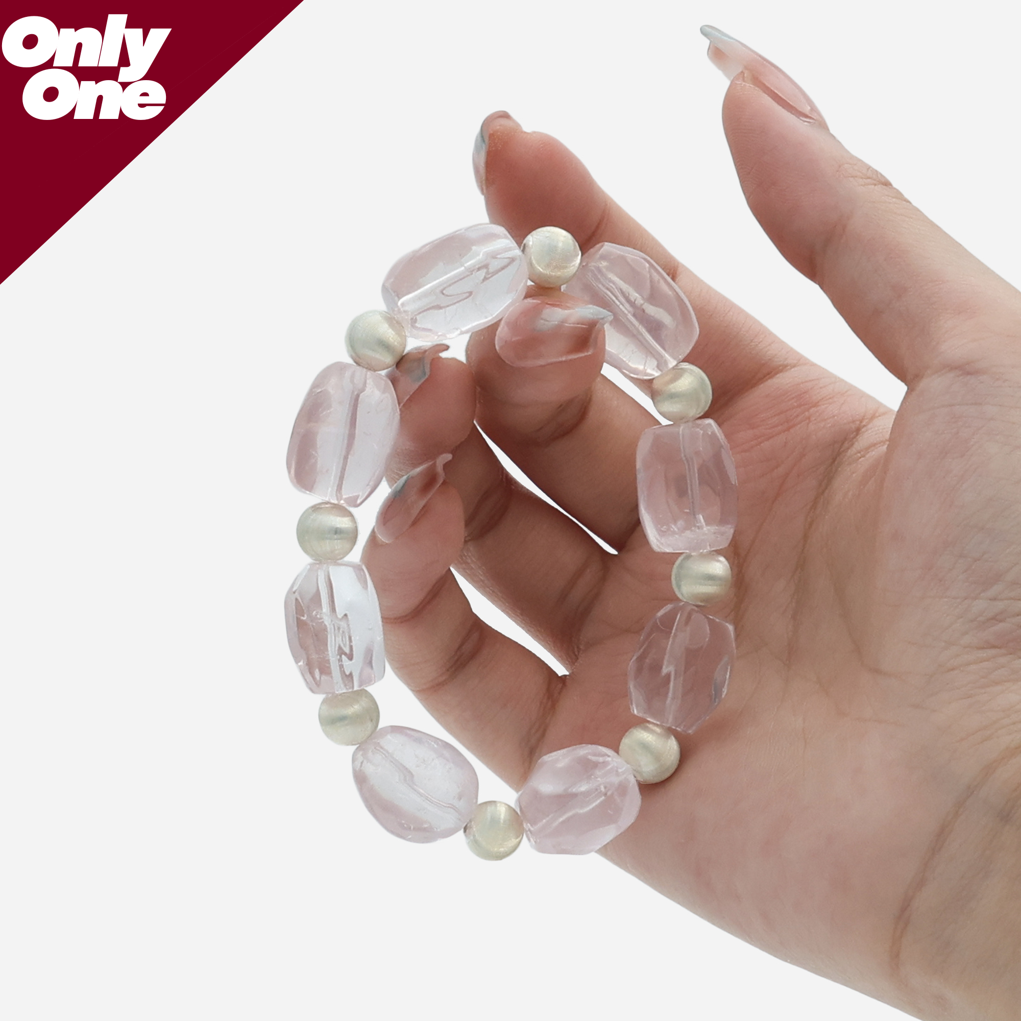 Detailed view of hand holding Rose Quartz strand, highlighting the natural organic shapes and matte silver texture.