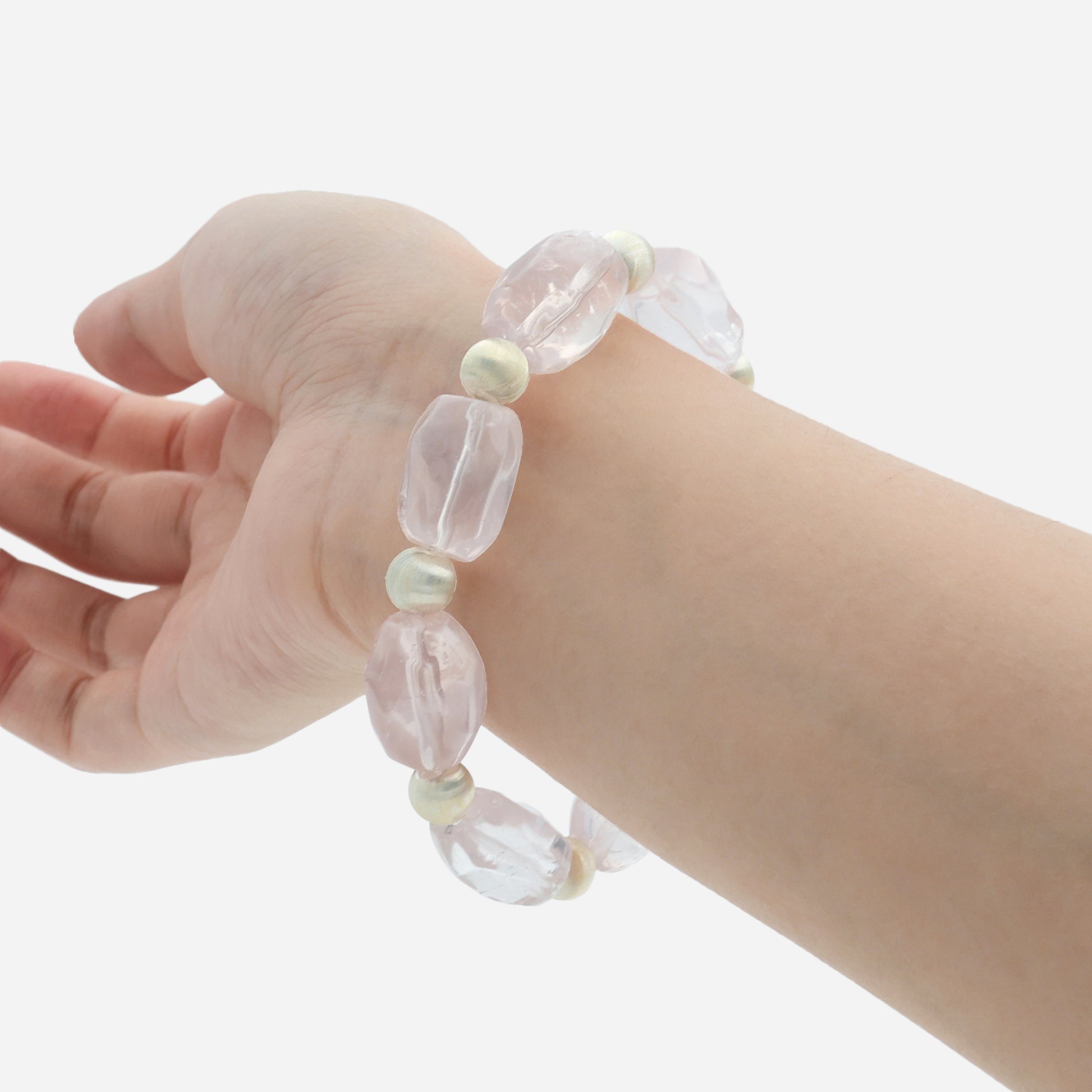 Rose quartz healing crystal bracelet worn on wrist showing the soft pink natural gemstone and stretch design