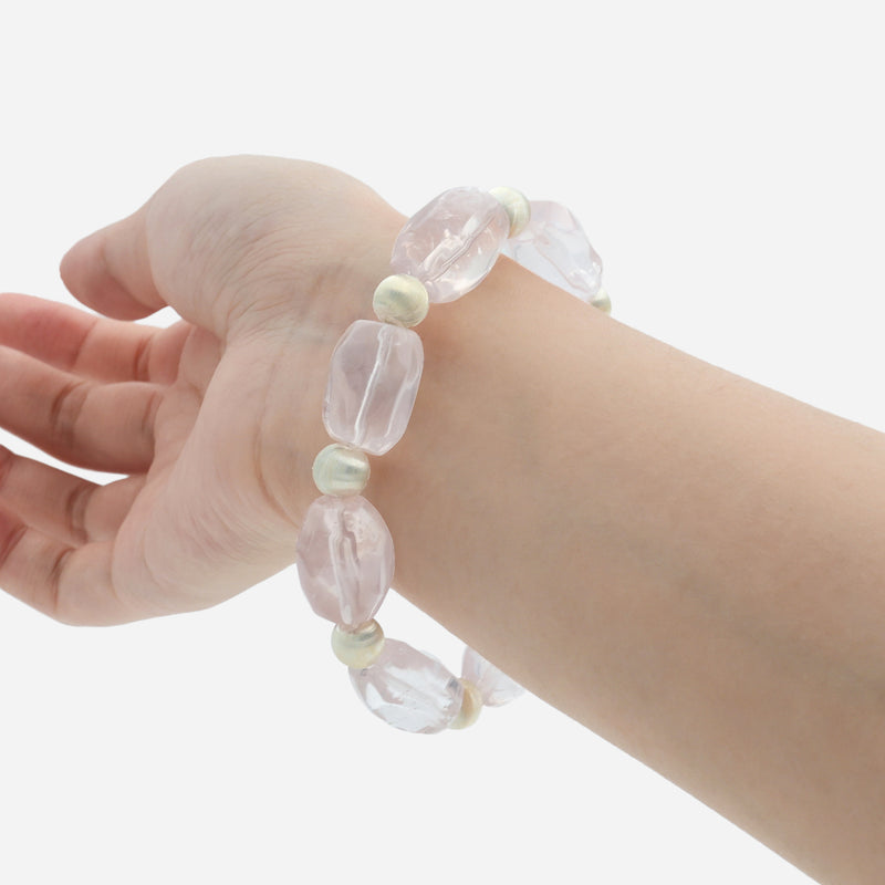 Rose quartz healing crystal bracelet worn on wrist showing the soft pink natural gemstone and stretch design