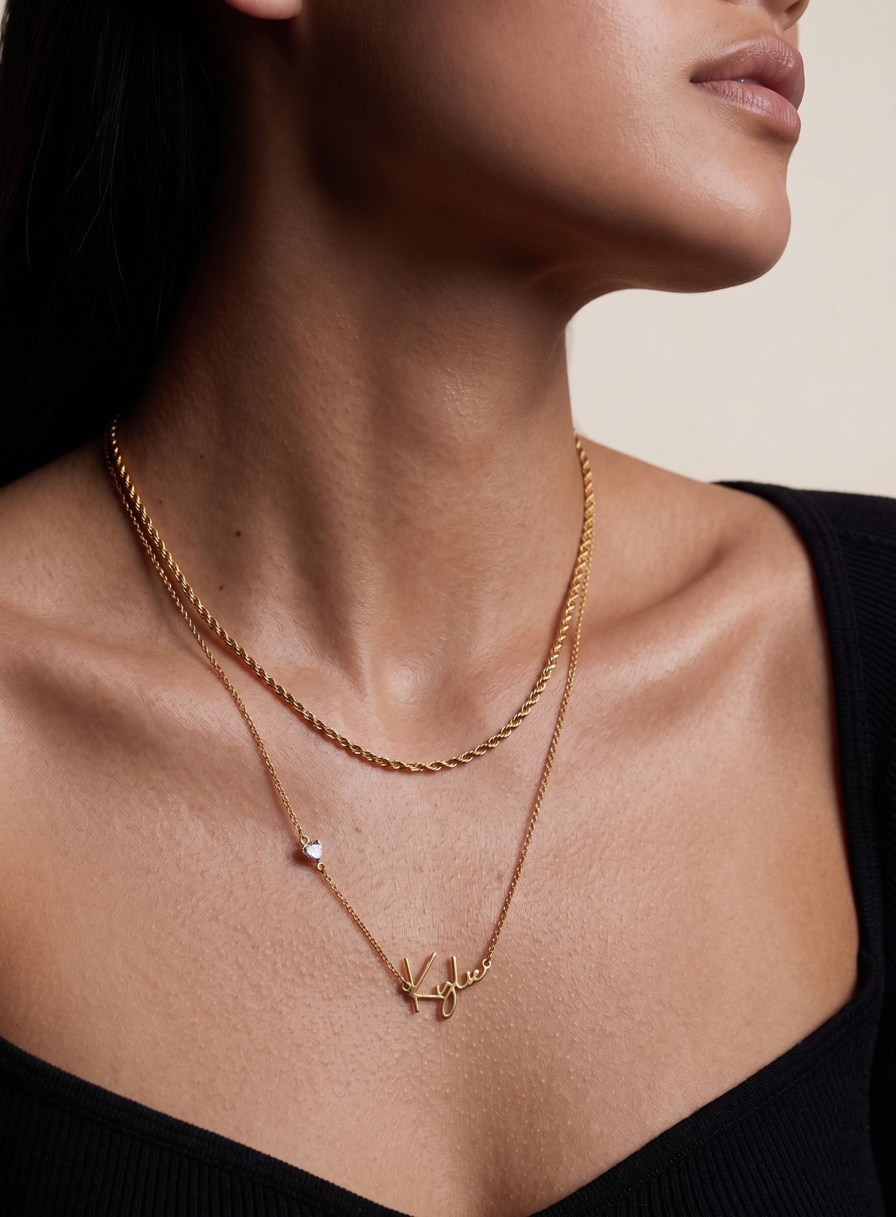 Close-up of custom cursive name pendant in 18K gold plated sterling silver with heart CZ charm detail