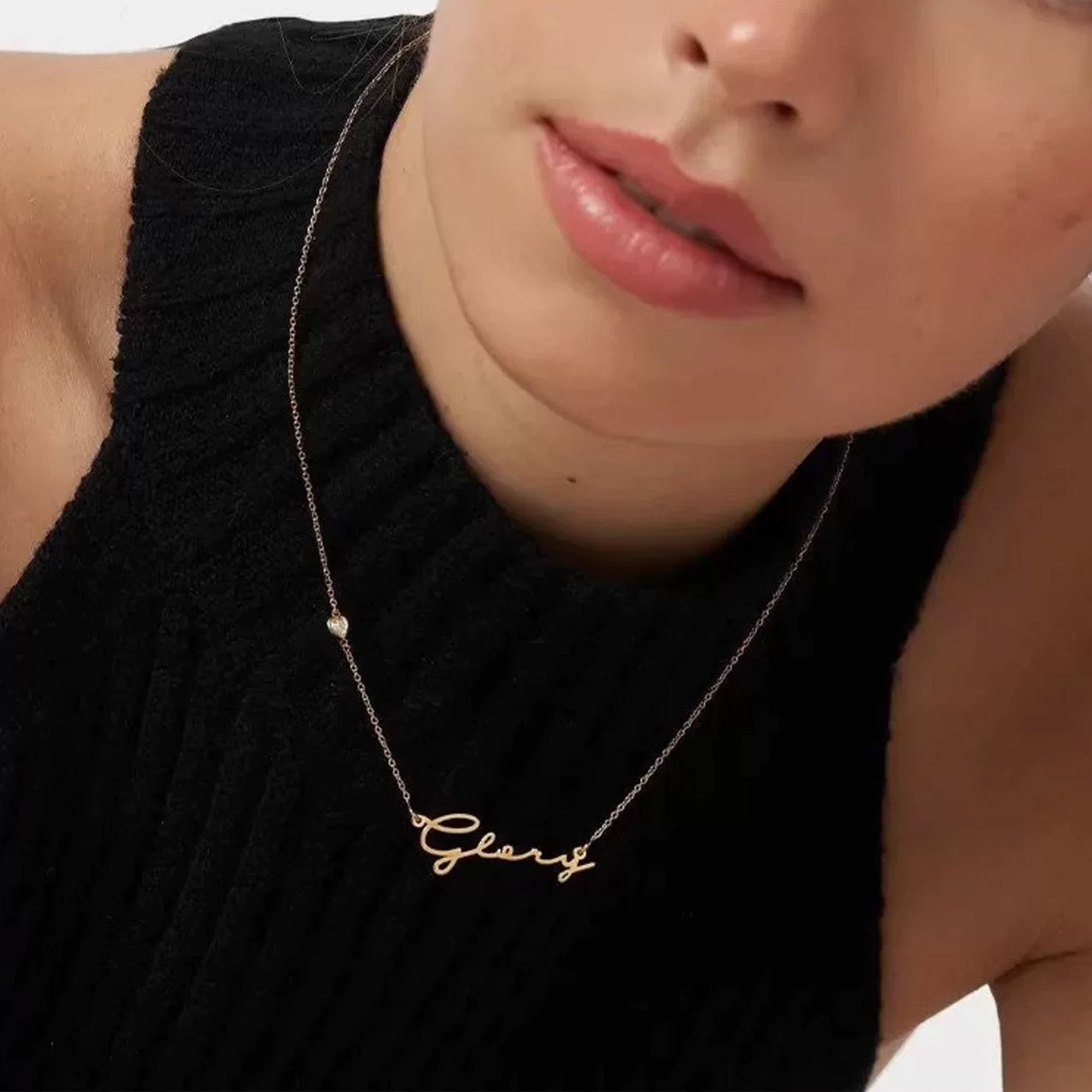 Close-up of custom cursive name pendant in 18K gold plated sterling silver with heart CZ charm detail