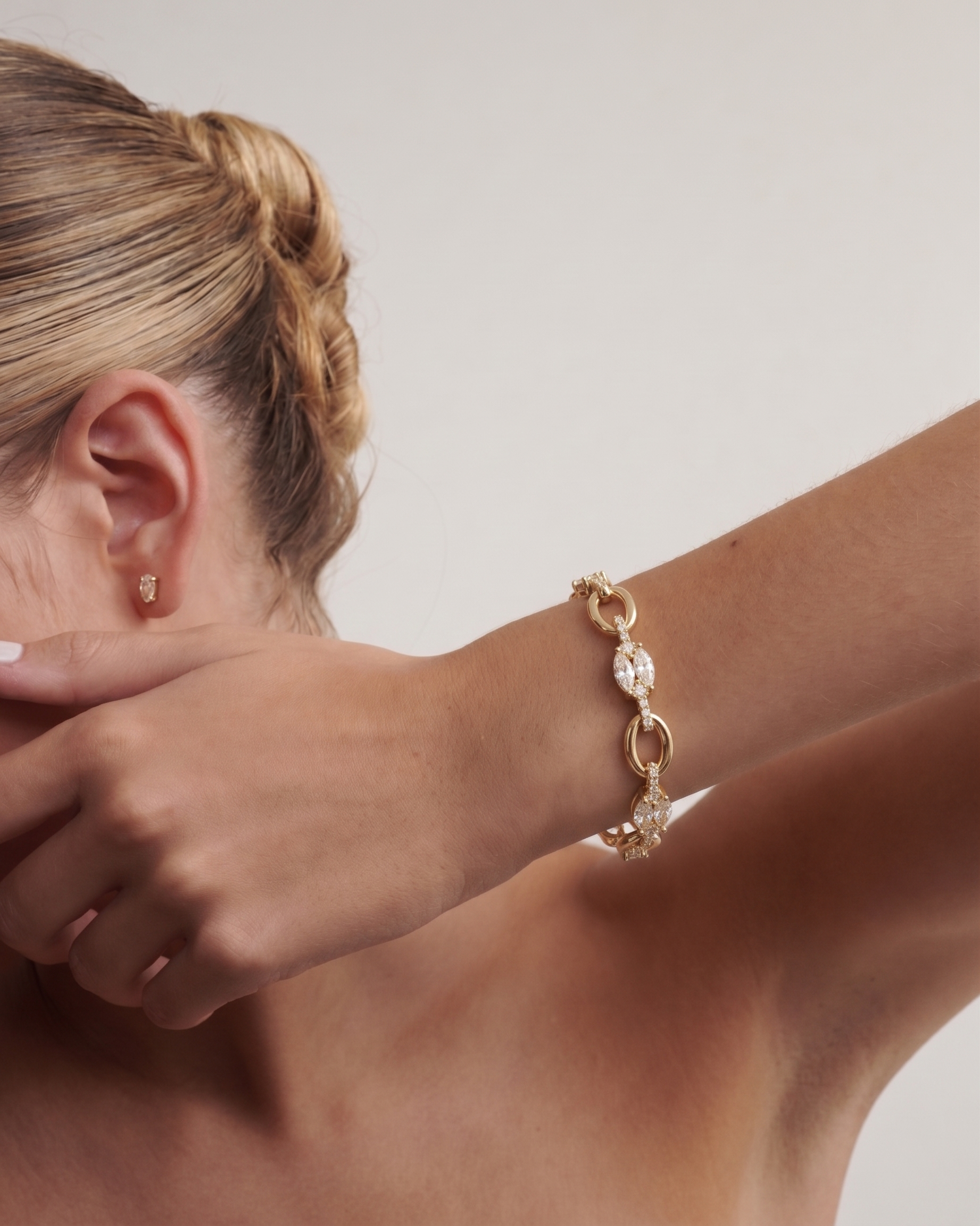 Marquise Garland Link bracelet worn on wrist showing dragon bite clasp and multi-cut lab diamond sparkle on gold chain