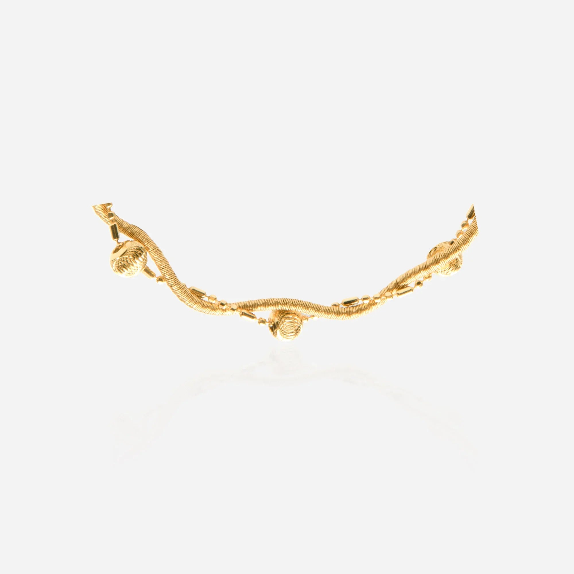 Close-up of Florentine brushed textured gold beads on twisted vine chain bracelet showing matte finish detail