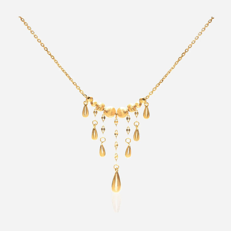 Teardrop fringe necklace worn showing Y-shaped elongating effect graduated drops framing decolletage