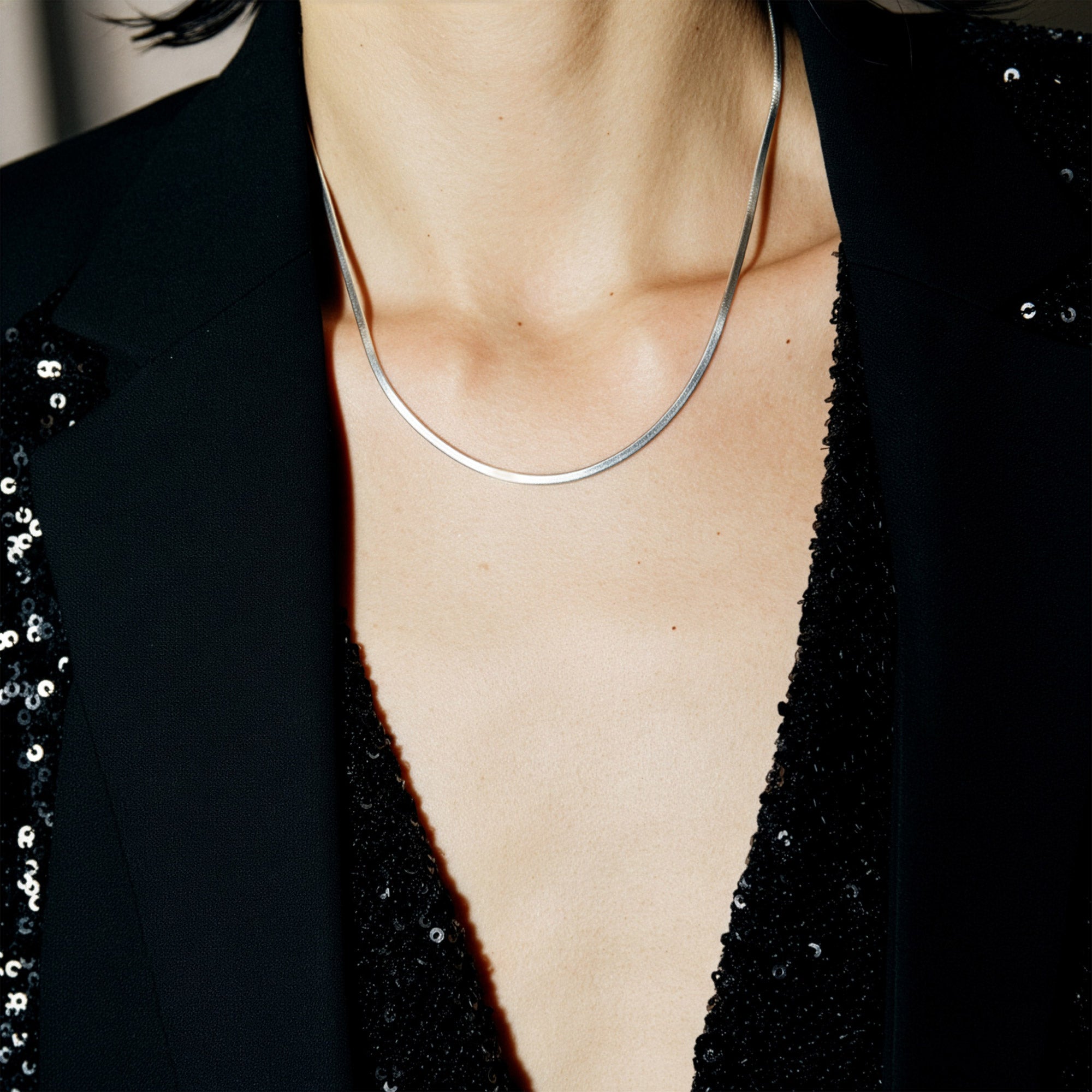 Flat snake chain necklace detail showing mirror-finish liquid gold herringbone pattern 18K gold plated solid 4.37g