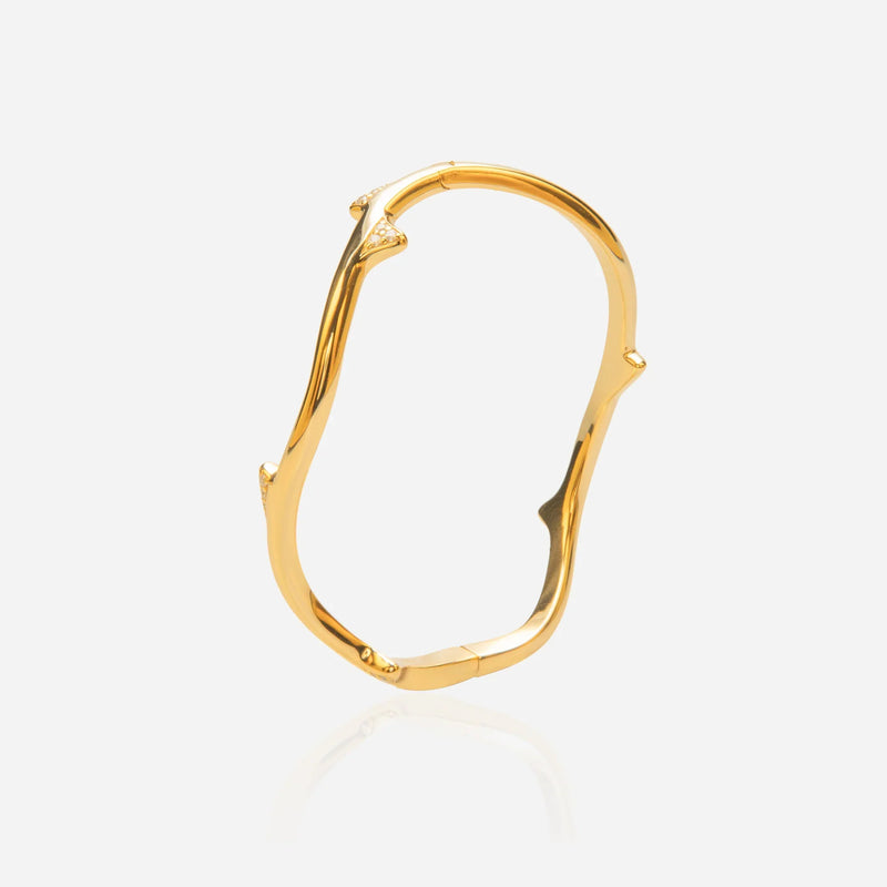 Gold rose stem bangle worn showing hinged closure and substantial weight 18k gold plated silver architectural design