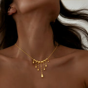 Gold teardrop fringe necklace Y-shaped design with 9 graduated drops mixed finish craftsmanship adjustable jewelry